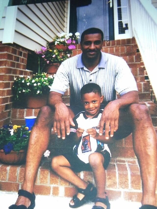 Tré Hunter as a young child sitting on the front steps with his father